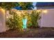 Backyard view of decorative blue vase set among landscape and white fence with garden lights at 3245 Freemont S Ter, St Petersburg, FL 33712