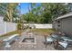 Relaxing backyard with a cozy fire pit, seating, and dual hammock swings for lounging at 3245 Freemont S Ter, St Petersburg, FL 33712