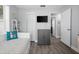 Bedroom with light blue walls, wood floors, a twin bed, TV, and natural light at 3245 Freemont S Ter, St Petersburg, FL 33712