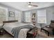 Bright bedroom featuring neutral walls, modern ceiling fan, a stylish chair, and an abundance of natural light at 3245 Freemont S Ter, St Petersburg, FL 33712