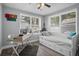 Sunlit bedroom with windows, ceiling fan, work station, and a daybed offering comfort and functionality at 3245 Freemont S Ter, St Petersburg, FL 33712