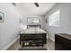 Cozy bedroom with natural light, features wood-look floors, a ceiling fan, and a stylish dark-wood decor at 3245 Freemont S Ter, St Petersburg, FL 33712