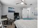 Bright bedroom featuring neutral walls, a TV on a stand, a stylish chair, and a ceiling fan at 3245 Freemont S Ter, St Petersburg, FL 33712
