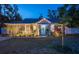 Charming home with a manicured lawn, decorative lighting, and a welcoming blue front door at 3245 Freemont S Ter, St Petersburg, FL 33712