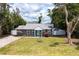 Well-kept home with a green lawn, lush flowers, and a bright blue door at 3245 Freemont S Ter, St Petersburg, FL 33712
