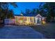 Beautiful home with vibrant landscaping, accent lights, and a well-maintained front yard at 3245 Freemont S Ter, St Petersburg, FL 33712