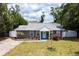 Charming gray home with a manicured lawn, landscaped garden beds and driveway at 3245 Freemont S Ter, St Petersburg, FL 33712