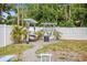Charming backyard hammocks offer a tranquil retreat, surrounded by lush greenery and a white fence at 3245 Freemont S Ter, St Petersburg, FL 33712