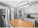 Well-lit kitchen featuring a stainless steel refrigerator, ample cabinetry, a breakfast table, and backyard access at 3245 Freemont S Ter, St Petersburg, FL 33712