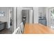 Kitchen with stainless fridge, and white cabinets with a wooden island that adds warmth and charm at 3245 Freemont S Ter, St Petersburg, FL 33712