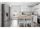 Bright kitchen has stainless appliances, a center island with seating, and backyard access at 3245 Freemont S Ter, St Petersburg, FL 33712