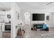 Inviting living room transitions to kitchen area, showcasing updated flooring and a stylish entertainment center at 3245 Freemont S Ter, St Petersburg, FL 33712