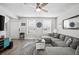 Cozy living room featuring a comfortable sectional sofa, modern rug, and ample natural light through large windows at 3245 Freemont S Ter, St Petersburg, FL 33712