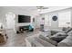 Bright living room features wood floors, modern furniture, and lots of natural light from large windows at 3245 Freemont S Ter, St Petersburg, FL 33712