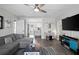 Bright living room featuring modern furnishings, hardwood floors, and an open view into the kitchen at 3245 Freemont S Ter, St Petersburg, FL 33712