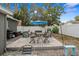 Charming backyard patio with outdoor seating, a grill, and an umbrella, perfect for relaxation and entertaining at 3245 Freemont S Ter, St Petersburg, FL 33712