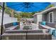 Outdoor living space with stylish patio furniture and a bright blue umbrella for shade at 3245 Freemont S Ter, St Petersburg, FL 33712