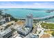 Sweeping aerial view featuring modern condo, waterfront access, and surrounding cityscape under a bright blue sky at 331 Cleveland St # 906, Clearwater, FL 33755