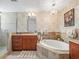 Bright bathroom boasts a soaking tub, modern fixtures, and decorative wallpaper at 331 Cleveland St # 906, Clearwater, FL 33755