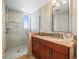 Modern bathroom featuring a glass-enclosed shower and wood cabinets with marble countertops at 331 Cleveland St # 906, Clearwater, FL 33755