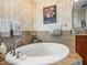 Close up on a stylish soaking tub with stone surround and elegant fixtures at 331 Cleveland St # 906, Clearwater, FL 33755