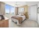 Cozy bedroom with a ceiling fan, a large window, and comfortable furnishings at 331 Cleveland St # 906, Clearwater, FL 33755