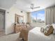 Bright bedroom with a large window offering city views, ceiling fan and warm accents at 331 Cleveland St # 906, Clearwater, FL 33755