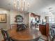 Open-concept dining room showcasing an elegant chandelier with views of the modern kitchen at 331 Cleveland St # 906, Clearwater, FL 33755