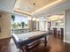 Spacious game room with a pool table, large windows offering scenic views, and a built-in bar area at 331 Cleveland St # 906, Clearwater, FL 33755