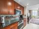 This kitchen features stainless steel appliances, dark countertops, and wood cabinets at 331 Cleveland St # 906, Clearwater, FL 33755