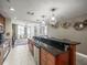 Bright kitchen features granite counters, stainless appliances and a breakfast bar with modern pendant lighting at 331 Cleveland St # 906, Clearwater, FL 33755