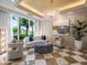 Elegant living room with checkerboard floors, designer furniture, and large windows at 331 Cleveland St # 906, Clearwater, FL 33755
