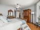Well-lit main bedroom features a spacious layout, wood floors, and a large wooden wardrobe at 331 Cleveland St # 906, Clearwater, FL 33755