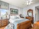 Comfortable main bedroom with wood floors, dresser, and art, creating a relaxing retreat at 331 Cleveland St # 906, Clearwater, FL 33755