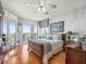 Serene main bedroom features wood floors, balcony access, and a calming neutral color scheme at 331 Cleveland St # 906, Clearwater, FL 33755