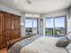 Cozy main bedroom offers stunning ocean views from the balcony, hardwood floors, and nice furnishings at 331 Cleveland St # 906, Clearwater, FL 33755