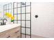 Modern bathroom features white subway tiles and a glass shower door with matte black trim at 351 Hancock St, Dunedin, FL 34698