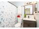 Charming bathroom featuring a vanity, toilet, and blue floral shower curtain with a fan above at 351 Hancock St, Dunedin, FL 34698