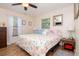Bright bedroom with a ceiling fan, hardwood floors, and two windows providing natural light at 351 Hancock St, Dunedin, FL 34698