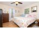 Bright bedroom with a ceiling fan, hardwood floors, and two windows providing natural light at 351 Hancock St, Dunedin, FL 34698