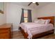 Cozy bedroom with wood furnishings and a large window providing natural light at 351 Hancock St, Dunedin, FL 34698
