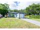 Beautiful single-story home with a well-maintained lawn, driveway, and colorful decorations at 351 Hancock St, Dunedin, FL 34698