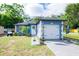 Inviting single-story home featuring a driveway, front yard, and charming curb appeal at 351 Hancock St, Dunedin, FL 34698
