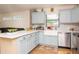 Bright kitchen with white countertops, light blue cabinets, and stainless steel appliances at 351 Hancock St, Dunedin, FL 34698