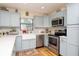 Bright kitchen with stainless steel appliances, white countertops, and light blue cabinetry at 351 Hancock St, Dunedin, FL 34698