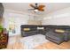 Cozy living room featuring hardwood floors, a ceiling fan, and comfortable gray sectional at 351 Hancock St, Dunedin, FL 34698