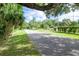 View down the street showcasing sidewalks, street parking and mature landscaping at 351 Hancock St, Dunedin, FL 34698