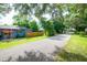 Wide street view of property showcasing landscaping and community at 351 Hancock St, Dunedin, FL 34698