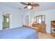 Bedroom with natural wood furniture, including dresser with large mirror at 37642 Landis Ave, Zephyrhills, FL 33541