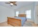 Bright bedroom with wooden sleigh bed, ceiling fan and natural light at 37642 Landis Ave, Zephyrhills, FL 33541